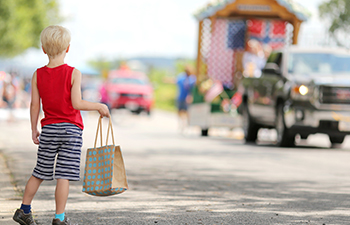 A kid waiting by the street for parade to come by in Schertz, TX